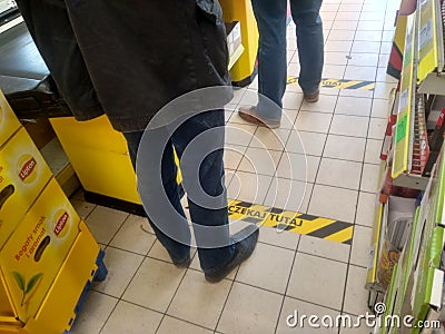 Distance markers stuck on the supermarket floor Editorial Stock Photo