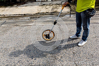 Distance measuring wheel device. Rolling distance measurement tool. Construction measuring tool. Measuring wheel tool for calculat Stock Photo