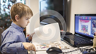 Distant education, online class meeting. Preschool boy studying during online lesson at home Stock Photo