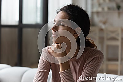 Mindful millennial hispanic female lost in sentimental thoughts Stock Photo