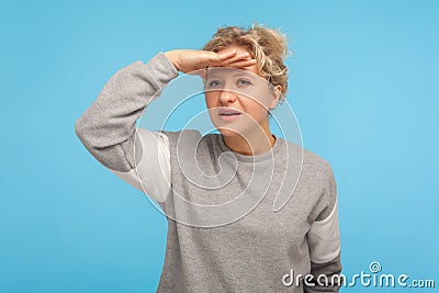 Distant view gesture. Woman attentively looking far away, keeping hand above eyes watching forward future Stock Photo