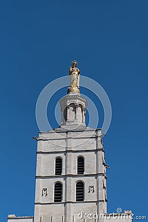 Distant view of the gilded statue overlooking Avignon cathedral in France Stock Photo