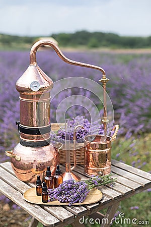 Distillation of lavender essential oil and hydrolate. Copper alambic for the flowering field. Stock Photo