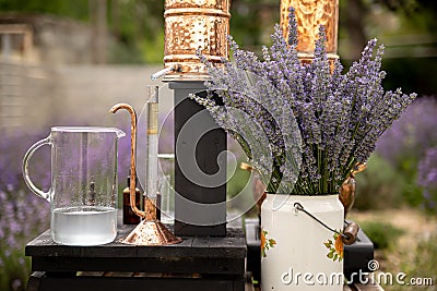 Distillation of lavender essential oil and hydrolate. Copper alambic for the flowering field. Stock Photo