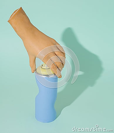 Distorted spray and hand touching the tip. Conceptual blue background Stock Photo