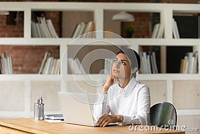 Motivated young indian business lady considering project risks. Stock Photo