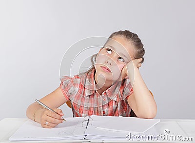 Distracted school kid at homework Stock Photo