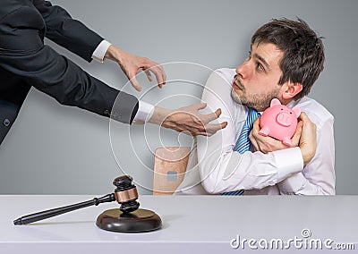 Distraint, bankruptcy and execution concept. Confiscation of savings in piggy money bank Stock Photo