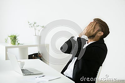 Distraught stressed bankrupt businessman covering face with hand Stock Photo