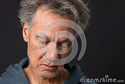 Distraught unshaven senior man at home Stock Photo