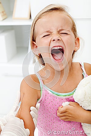 Distressed little girl getting an injection Stock Photo
