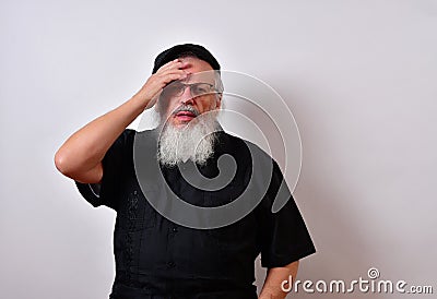 Distressed senior man holding his forehead in despair Stock Photo