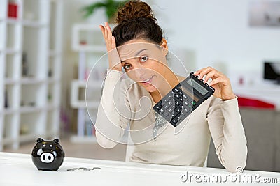 distressed woman holding calculator hand on forehead Stock Photo