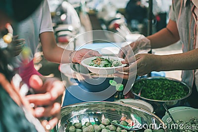 Distributing food to help the poor in society : Sharing food to the hungry : Food donation concept Stock Photo