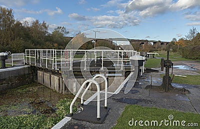 Disused lock gates with weed grown due to lack of use Stock Photo