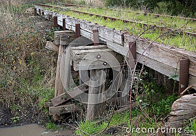 Disused railway timber trestle crossing over a water chanel in Dalton Victoria Stock Photo