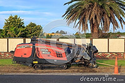 A `Ditch Witch` JT2020 horizontal directional drill beside a road Editorial Stock Photo