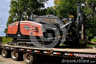 Ditch Witch Trencher loader on a flat bed trailer Editorial Stock Photo