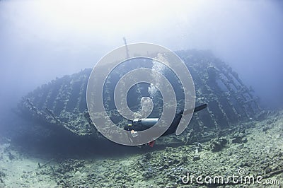 Diver exploring a large shipwreck Stock Photo