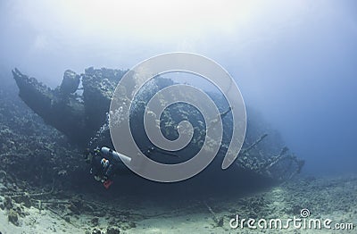 Diver exploring a large shipwreck Stock Photo