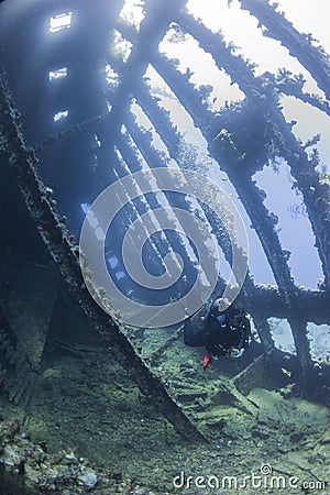 Diver exploring a large shipwreck Stock Photo