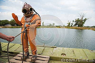 Diver immerses in a vintage deep sea diving suit Editorial Stock Photo