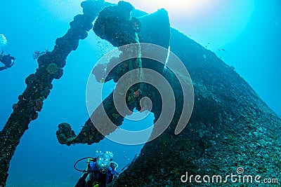 Diver near propeller ship wreck in the blue sea Stock Photo