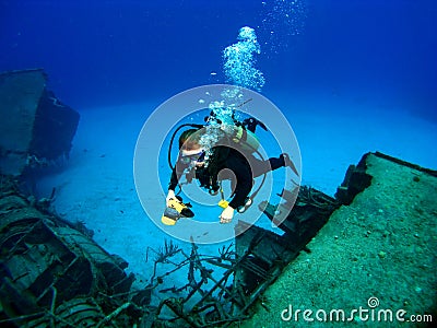 Diver photographing a Sunken Shipwreck Stock Photo