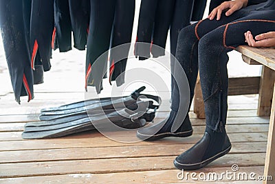 The diver puts on fins. Diver and equipment. Wetsuit fins and diving equipment close-up Stock Photo