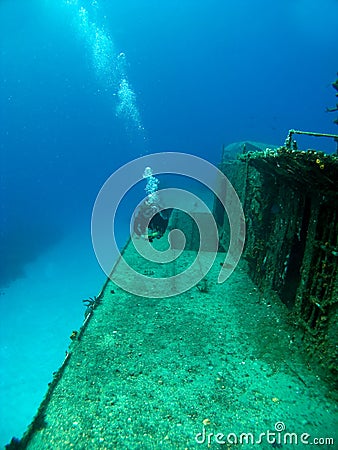 Diver swimming along side a Sunken Shipwreck Stock Photo