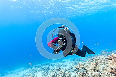 Diver swimming under water Stock Photo