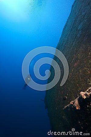 Diver underwater with sunken ship Stock Photo