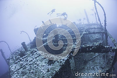 Divers on a deep underwater shipwreck Stock Photo