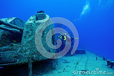 Divers exploring a shipwreck Stock Photo