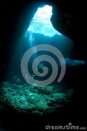 Divers in a Lava Tube Stock Photo