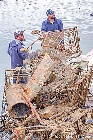 Divers removing dumped scrap and rubbish from alicante harbour Editorial Stock Photo