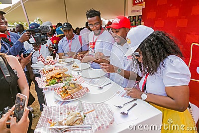 Diverse African judges tasing and scoring meals at cooking competition Editorial Stock Photo