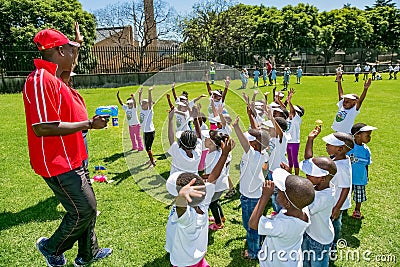 Diverse African Primary School children doing physical exercise PT lesson Editorial Stock Photo