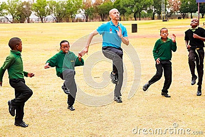 Diverse African Primary School children doing physical exercise PT lesson Editorial Stock Photo