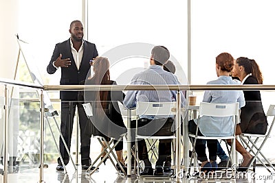 Diverse business team listening presentation of african coach at training Stock Photo