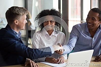 Diverse businessmen finish successful negotiations with handshake Stock Photo