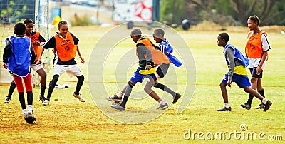 Diverse children playing soccer football at school Editorial Stock Photo