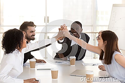 Diverse colleague giving high five, celebrating corporate success Stock Photo