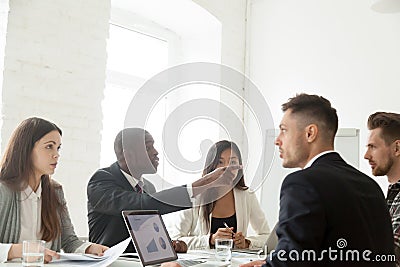 Diverse colleagues disputing during work meeting Stock Photo