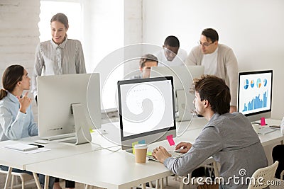 Diverse corporate employees group working together using compute Stock Photo
