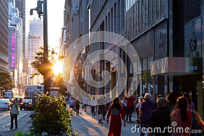 Diverse crowds of people walk down the busy sidewalks on 34th Street through Midtown Manhattan in New York City Editorial Stock Photo