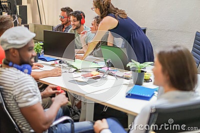 Diverse culture people working with computers at startup in creative office - Young guys discussing new marketing campaign - Stock Photo