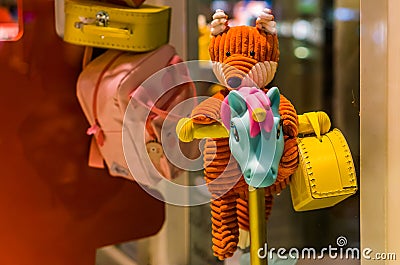 Diverse cute children toys, stuffed animal, unicorn scooter and some school bags Stock Photo