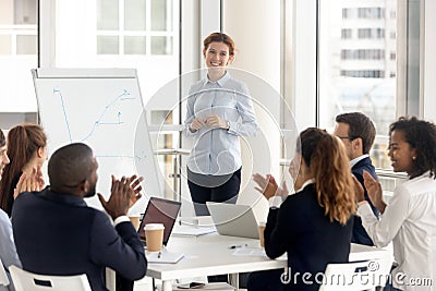 Diverse employees applaud thanking coach for training Stock Photo