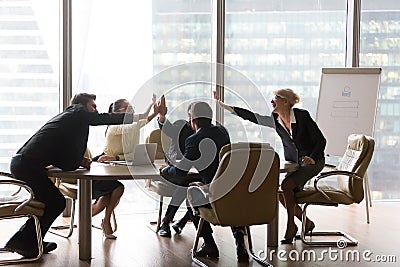 Diverse executive business team give high five in modern office Stock Photo